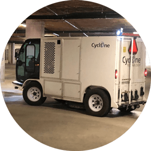 A white truck parked in a parking garage.