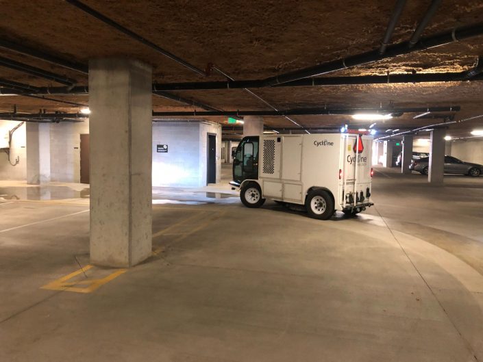 A truck parked in an empty parking garage.