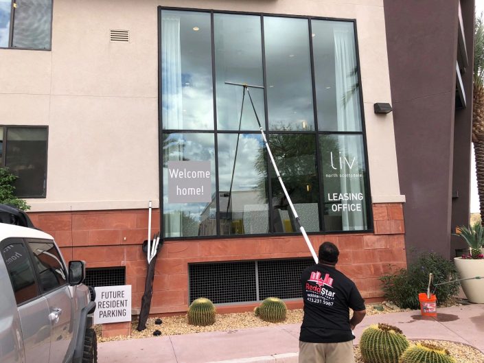 A man is cleaning the windows of a building.