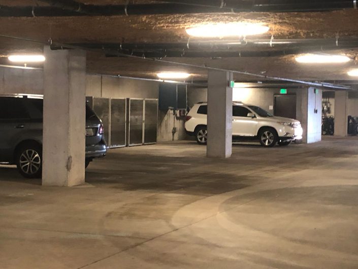 A car parked in the middle of an empty parking garage.