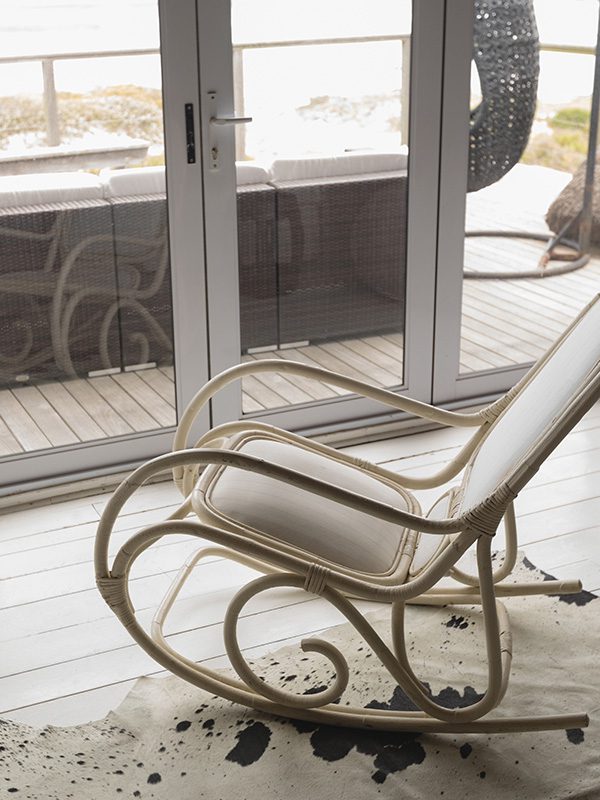 A rocking chair sitting on top of a wooden floor.