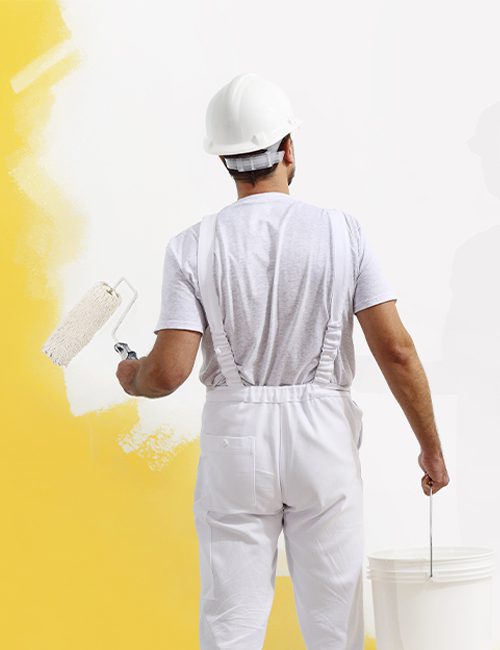 A man in white shirt and hard hat painting wall.