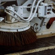 A close up of an industrial floor sweeper